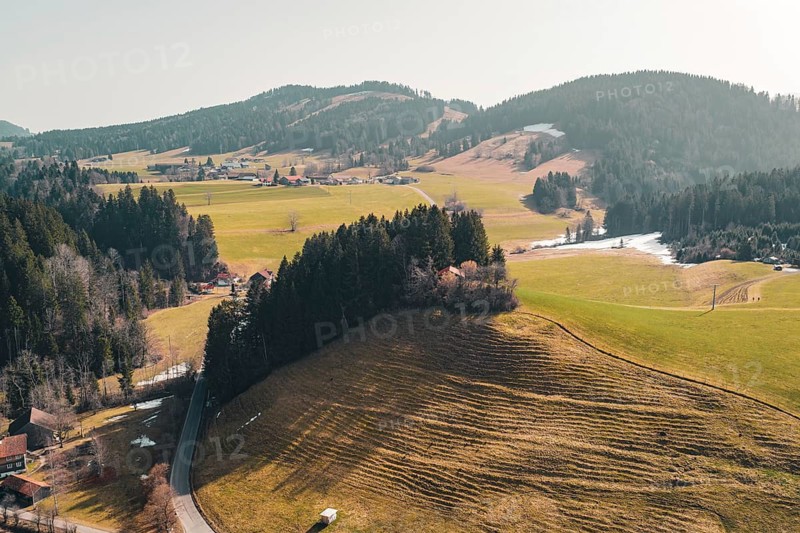 Gentle hills and forests surround a village in a peaceful spring landscape, Oberreute, Allgäu, Germany