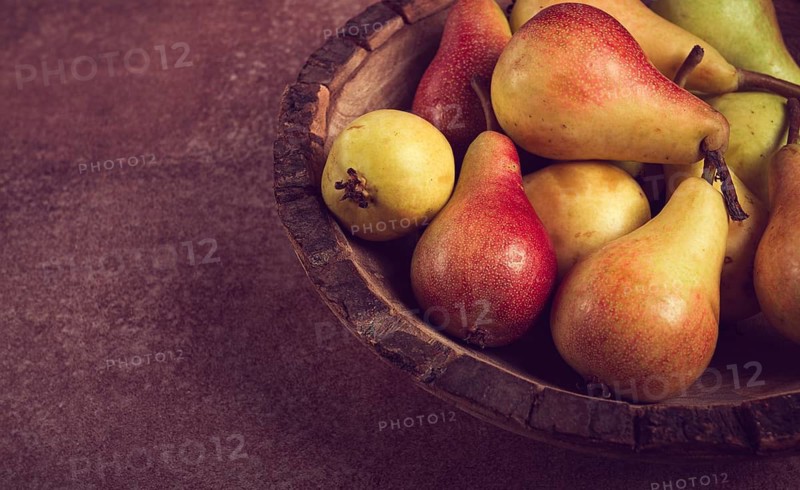 Pears, Duchess variety, small pears, early harvest, in a wooden plate, top view, no people