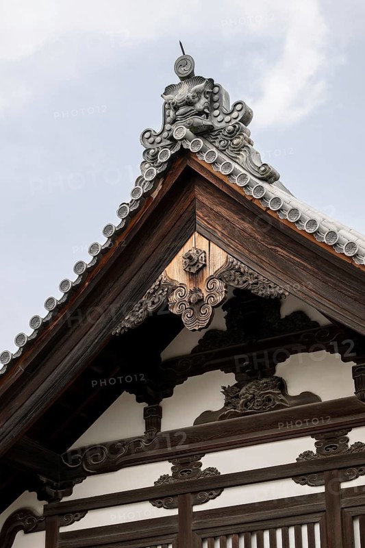 Close-up of intricate wooden carvings and traditional roof design at Kinkaku-ji Temple in Kyoto, Japan, highlighting the exquisite craftsmanship and rich cultural heritage