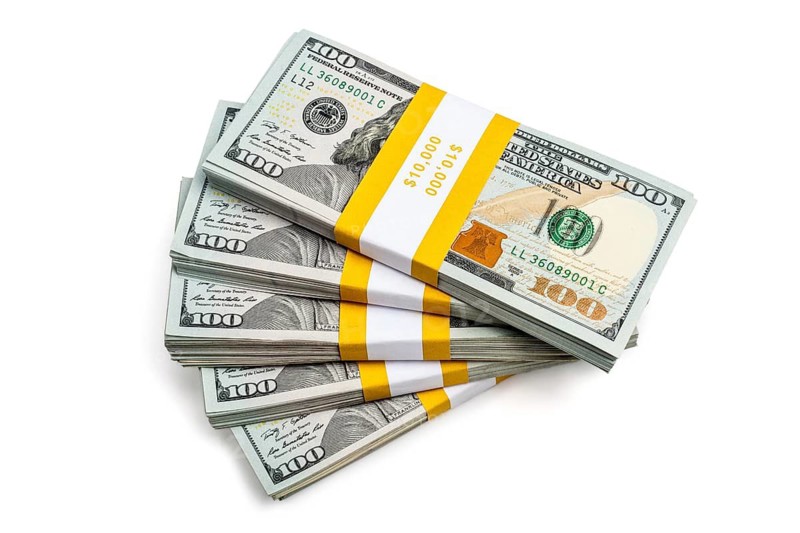 Creative business finance making money concept, stack of bundles of 100 US dollars 2013 edition banknotes bills isolated on white