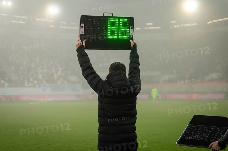 Technical referee shows players substitution during football match in Lubin, Poland