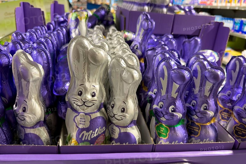 Display on retail shelf of wholesale chocolate Easter bunnies chocolate Easter bunnies wrapped in purple purple silver silver coloured staniol paper, Germany