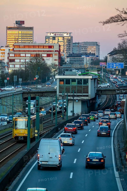Motorway A40, Ruhr expressway, heavy traffic jam, rush hour, city passage in Essen, skyline of the city centre, underground line between the lanes, Hobeisenbrücke stop, North Rhine-Westphalia, Germany