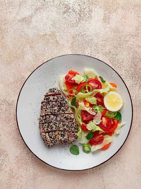 Fillet of red tuna meat, fried in sesame seeds, homemade, close-up, no people, on a wooden background