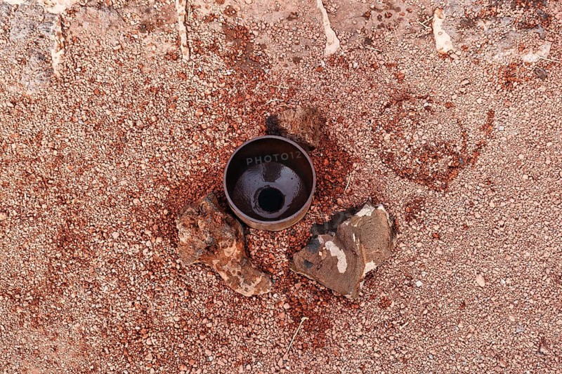 Pipe in fissure, demonstration for tourists, volcanic activity, steam geyser, fire mountains of Timanfaya National Park, Montanas del Fuego, Lanzarote, Canary Islands, Spain