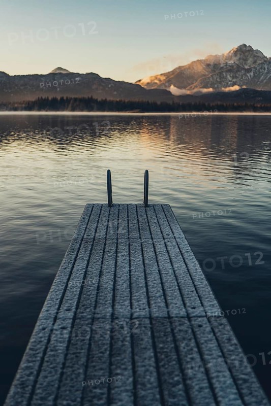 Frosty morning atmosphere during sunrise at Lake Hopfensee in the Allgäu in Bavaria, Germany