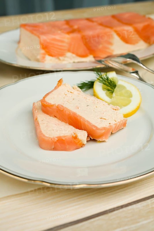 Southern German cuisine, salmon trout terrine arranged on a plate, salmon terrine with trout fillets, fish dish, salmon fillets, smoked salmon, starter, fine dining, Sunday crockery with gold rim, grandma's service, lemons, dill, fish cutlery, food photography, studio, Germany