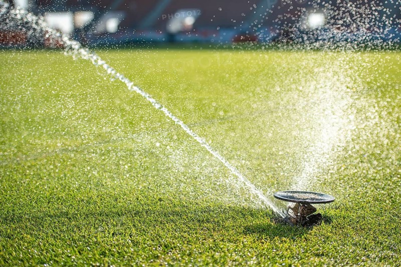 Watering grass at the football stadium