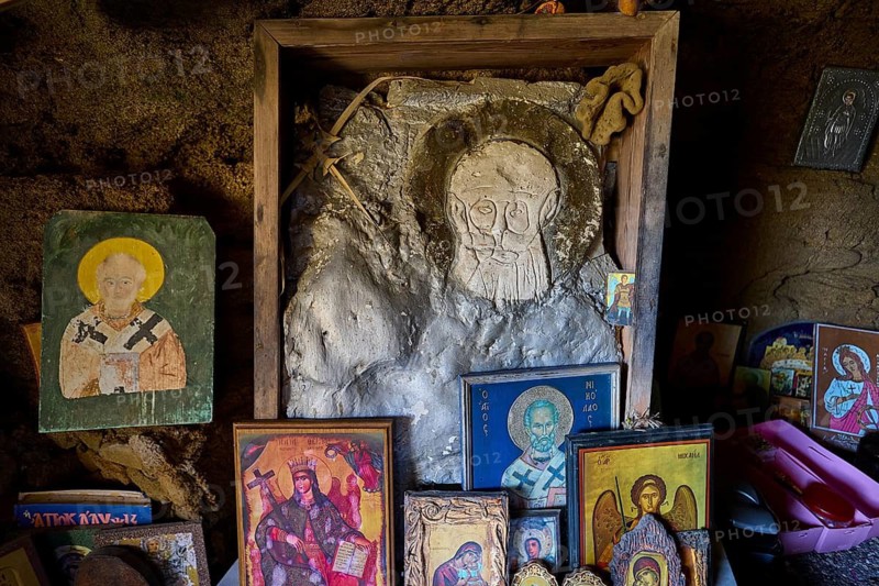 Stone sculpture and icons in a cave, mystical religious atmosphere, chapel, Agios Nikolaos, rock chapel, Oasis Beach, east coast Rhodes, Rhodes, Dodecanese, Greek Islands, Greece