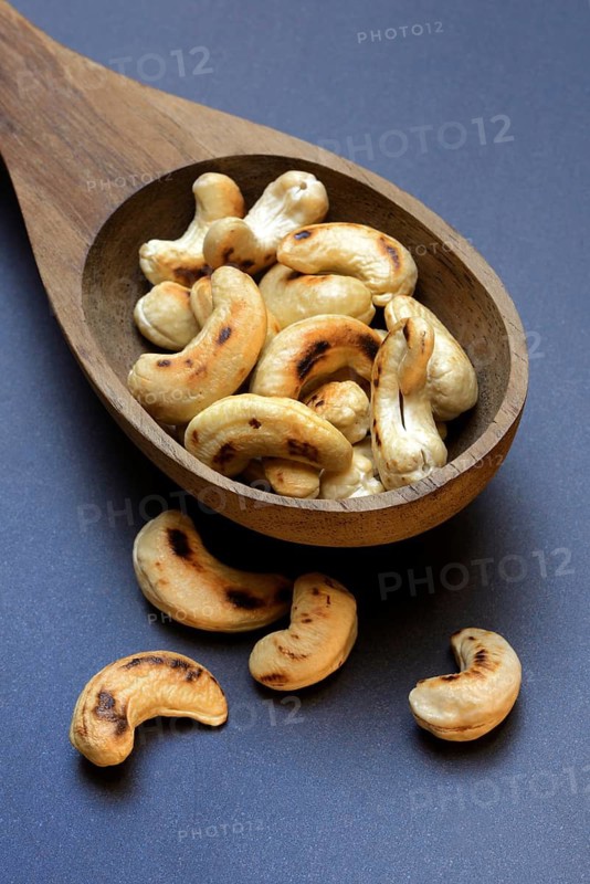 Cashew, roasted cashews in wooden ladle