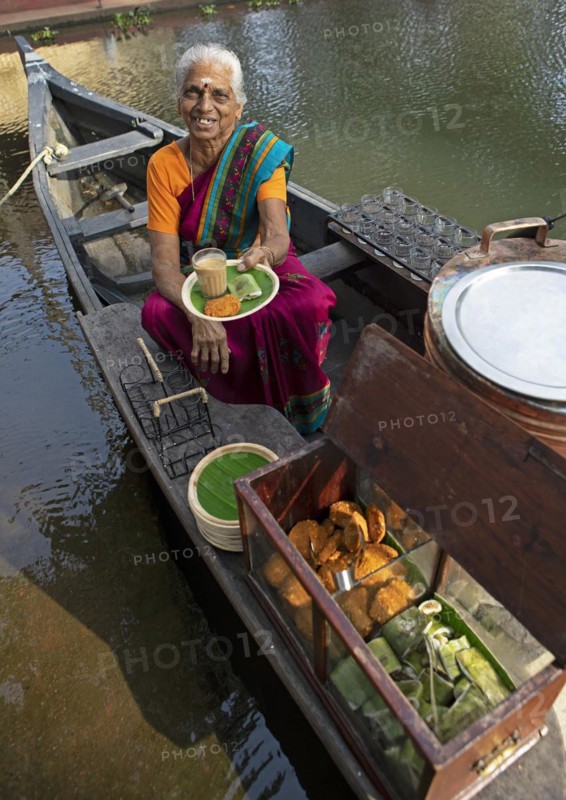 Tealady, 83 years old, shows an Indian tea on her boat, Backwaters, Kumarakom, Kerala, India