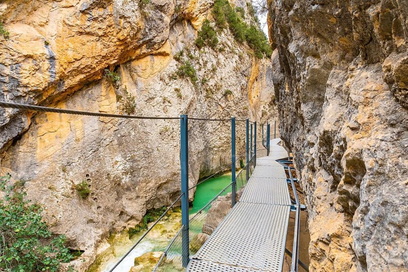 Walking along the metal walkways of the Vero River path in Alquezar. Pyrenees