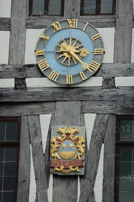 City coat of arms and golden clock at historic town hall, half-timbered house, detail, Michelstadt, Odenwald, Hesse, Germany