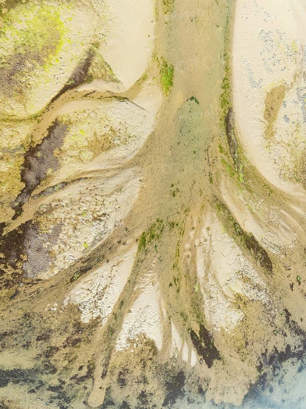 Sandy deposits, channels and streams at low tide at the Lago de la Gaviota (lake of the seagull). Aerial view. Drone shot. Isla Cristina, Huelva province, Andalusia, Spain