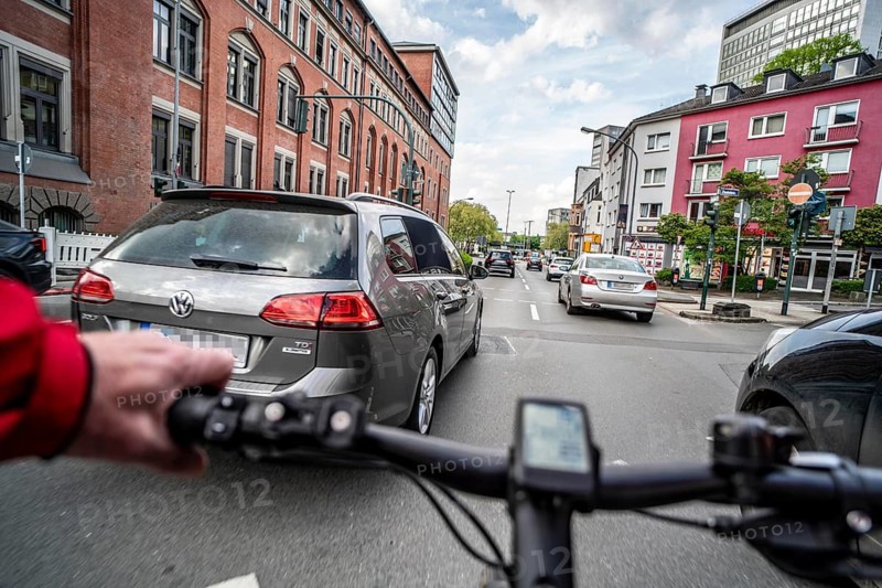 Cycling in the city, city centre road, no cycle lane, two-lane traffic in both directions, cyclists' perspective, Essen, North Rhine-Westphalia, Germany