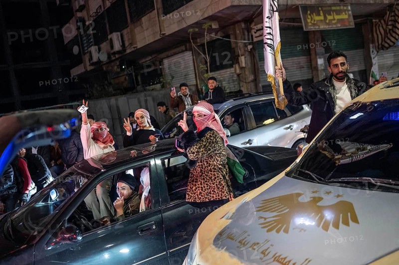 Damascus, Syria. December 7th 2025. Syrian women show the V for victory sign as they drive around the streets of Damascus in celebration of one year since the fall of the Assad regime, Damascus, Syria