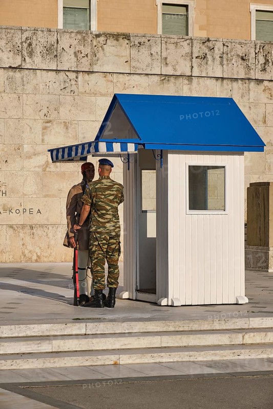 ATHENS, GREECE, MAY 20, 2010: Supervising Corporal of the Change fixes presidential ceremonial guard Evzone costume in front of the Monument of the Unknown Soldier near Greek Parliament, Syntagma square, Athenes, Greece