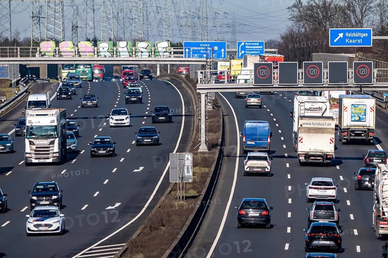 A57 motorway near Kaarst in the Rhein-Kreis Neuss, view towards Kaarst motorway junction, heavy traffic, overhead line, high-voltage lines, along the motorway, North Rhine-Westphalia, Germany