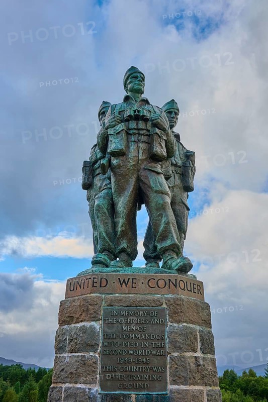 Three soldiers in a bronze statue with inscription 'United We Conquer', dramatic sky, Commando Memorial, Spean Bridge, Scotland, United Kingdom, Great Britain