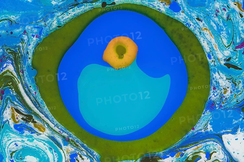 An abstract image showcasing a vibrant mixture of blue, green, and white colors with a bold blue circle and a central yellow dot