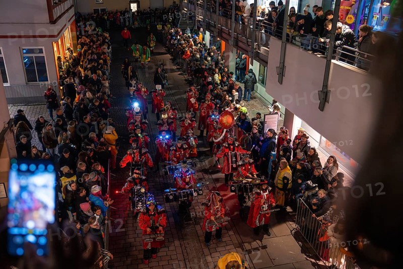 Music band in red uniforms at a night-time street party with many spectators, carnival, Calw, Black Forest, Calw district, Germany