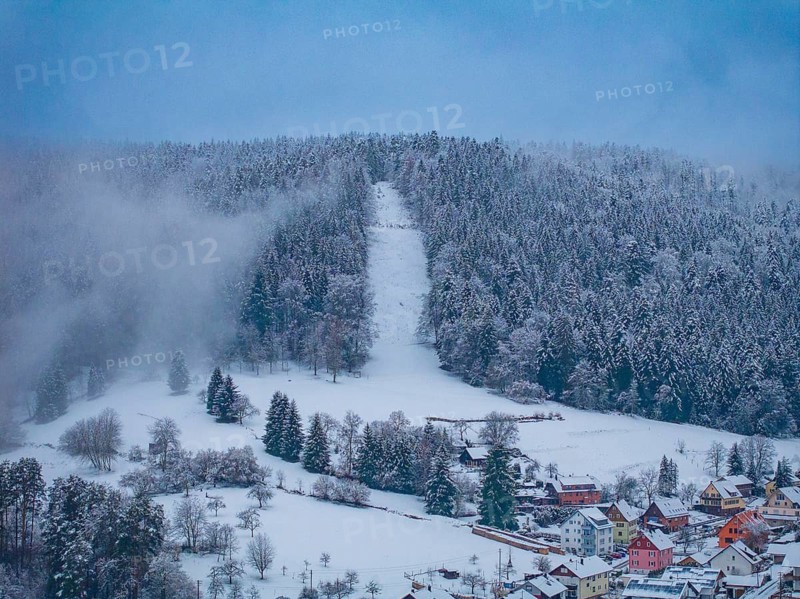 Wooded hills in winter with visible ski slope and dense fog, Enzklösterle, district of Calw, Black Forest, Germany