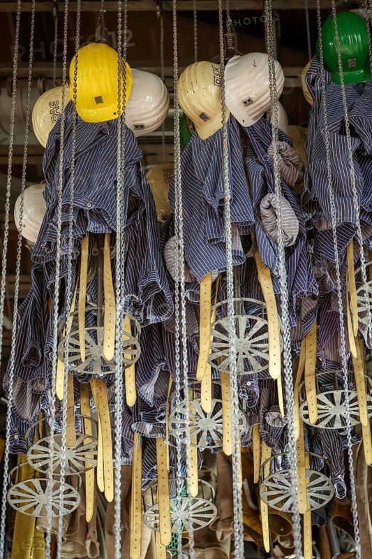 Dortmund, North Rhine-Westphalia, Germany - LWL-Industriemuseum Zeche Zollern. Miners' clothing hangs in baskets under the ceiling in the former washing room. The Zollern colliery is a disused coal mine in the north-west of the city of Dortmund, in the Bövinghausen district
