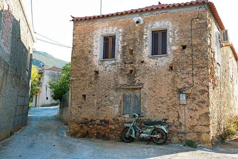 Moped at a morbid house in Agios Nikolaos, Laconia, Peloponnese, Greece