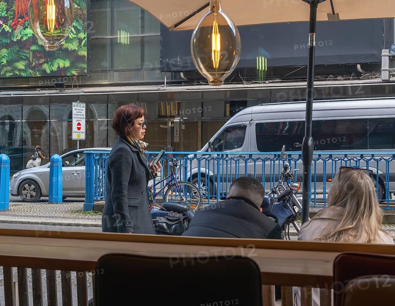 View through the window of a café of passers-by on Friedrichstraße in Mitte, Berlin, Germany