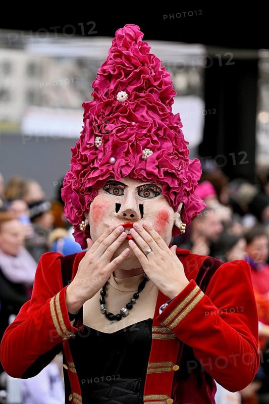 Person dressed up as a lady with a hat at the Wey guild on Rose Monday, Güdismäntig, Lucerne Carnival 2024, Lucerne, Switzerland