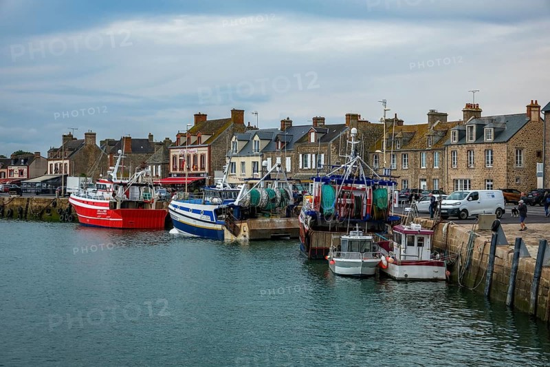 Barfleur, Normandy, France - Fishing boats on the quay in the harbour of Barfleur, a picturesque fishing village, a French commune in the Manche department on the Cotentin peninsula in the Normandy region, behind the famous Café de France