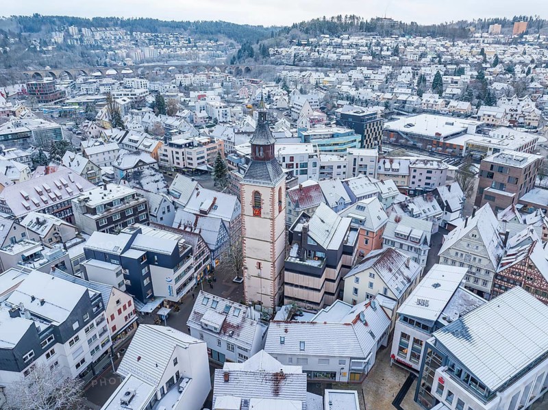 City panorama with snow and dominating church tower, snow-covered roofs, Nagold, Black Forest, Germany