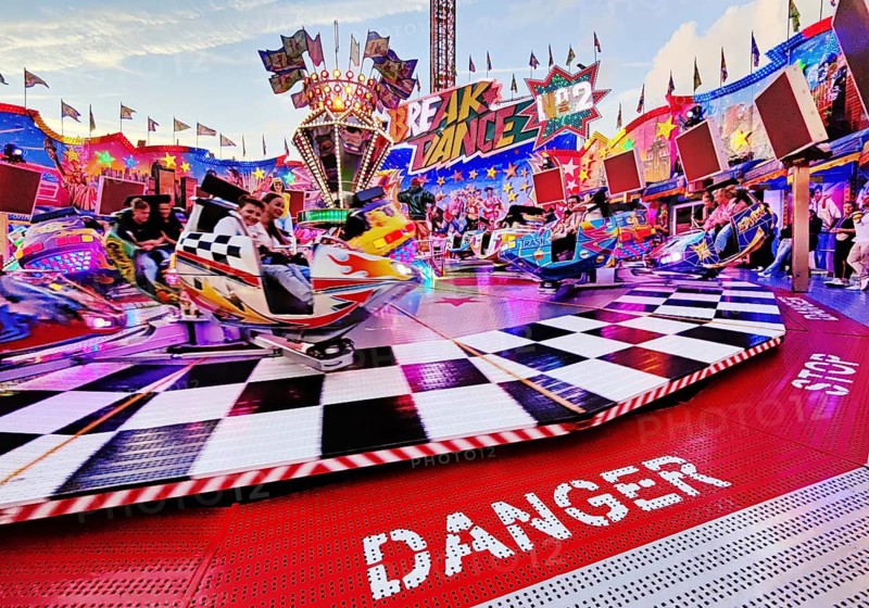 People on the illuminated carousel Break Dance in the evening, Cranger Kirmes, Herne, Ruhr area, North Rhine-Westphalia, Germany