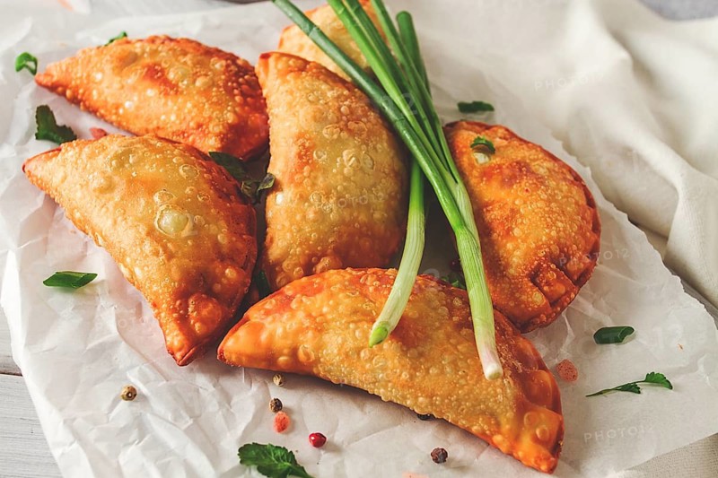 Fried chebureks, close-up, on a light background, no people