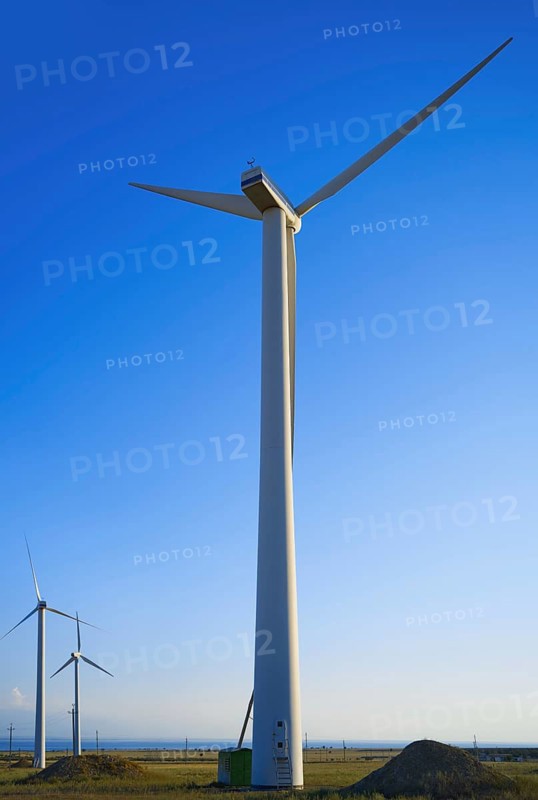 Majestic wind turbines against a clear blue sky in California, USA. The scene captures the essence of renewable energy and technology amidst a serene natural setting