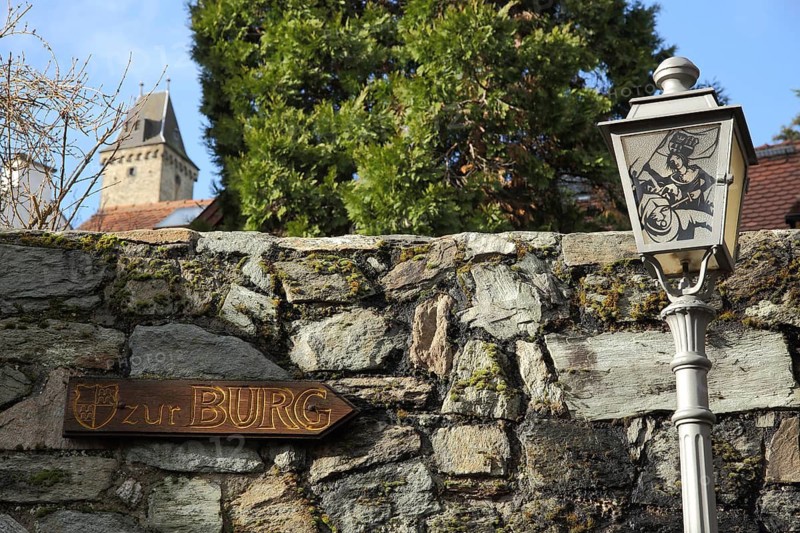 Information sign with castle inscription and street lamp, tower, Kronberg, Taunus, Hesse, Germany