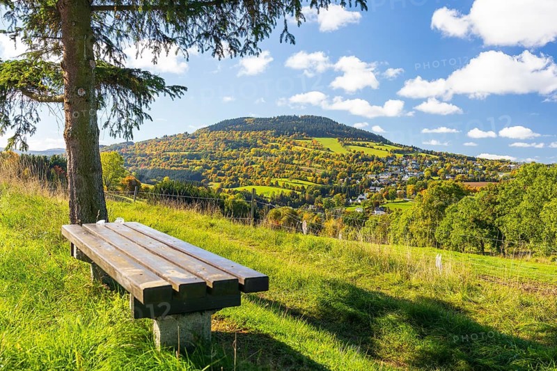 Bench with view of the Pöhlberg with Geyersdorf in autumn, Erzgebirge, Saxony, Germany