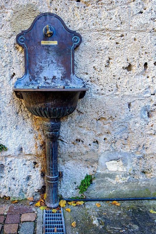 Public water supply, tap with drinking water connection and drainage basin at the town museum Klostermühle, Bad Urach, Swabian Alb, Baden-Württemberg, Germany