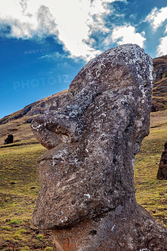 Close-up of a Moai statue with dramatic cloudscape in the background, The Moai statues on Easter Island in the Pacific Ocean