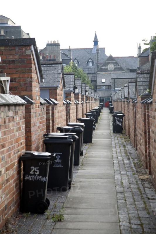 Back alley with rubbish bins. The Railway Village built by GWR to house workers in the 1840s, Swindon, England, United Kingdom
