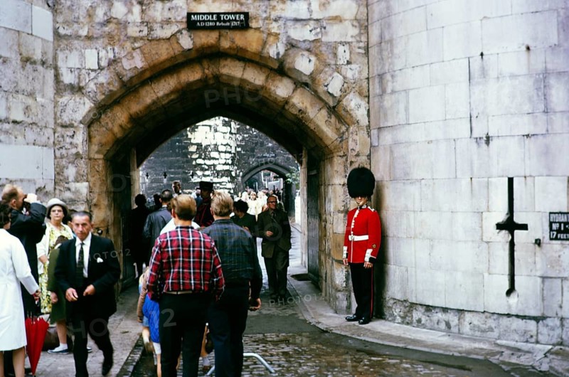 Guardsman standing Middle Tower, Tower of London busy with tourists in 1966, London, England, Great Britain