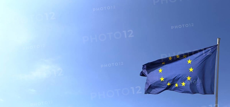 Flag of the European Union in front of a blue sky (Flag of the European Union in front of a blue blue sky)