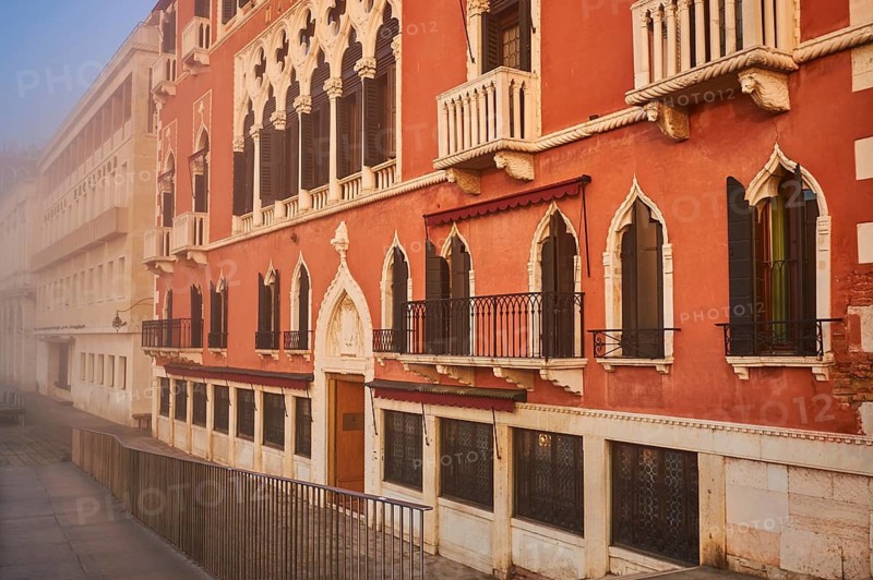 View from 'Colonna di San Marco e San Teodoro' on a house at sunrise in Venice on a foggy morning in winter, Italy