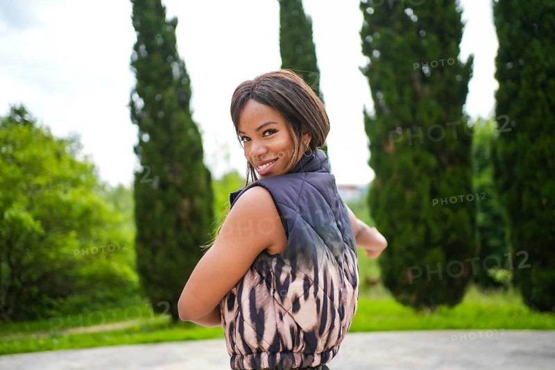 Cute female latin sensual beauty dancer turning to smile at camera dancing salsa alone in an urban park