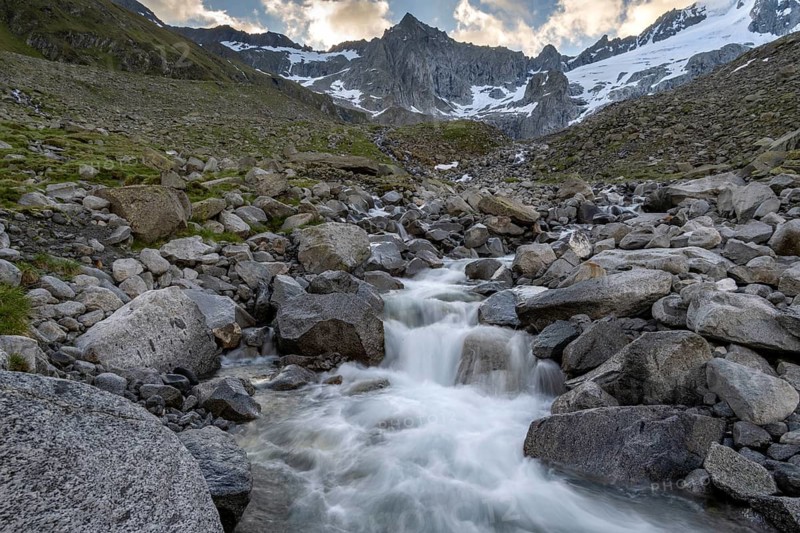 Mountain stream Furtschaglbach at sunrise, long exposure, rocky mountains behind, summit Furtschaglspitze with glacier Furtschaglkees, Furtschaglhaus, Berliner Höhenweg, Zillertal, Tyrol, Austria