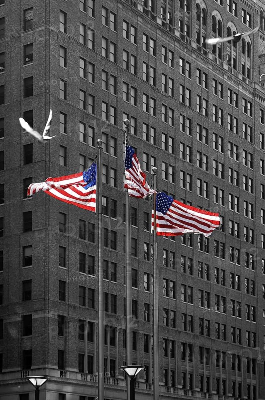 Waving US flags behind skyscraper, New York City, USA