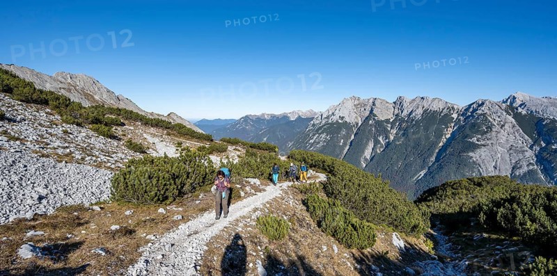 Mountaineers on a hiking trail, autumnal mountain landscape, ascent to the Große Arnspitze, view of mountain peaks of the Karwendel, near Scharnitz, Bavaria, Germany