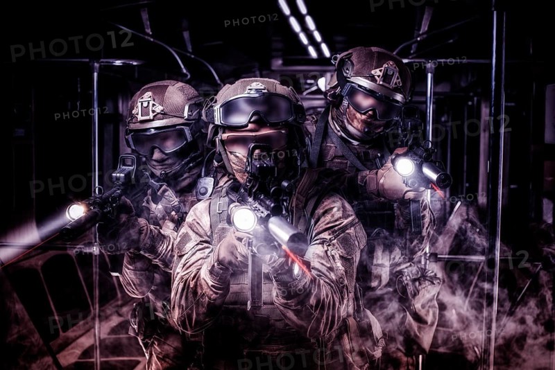 Soldiers of a special anti-terrorist unit storm a railway carriage in the subway. Special operation concept.