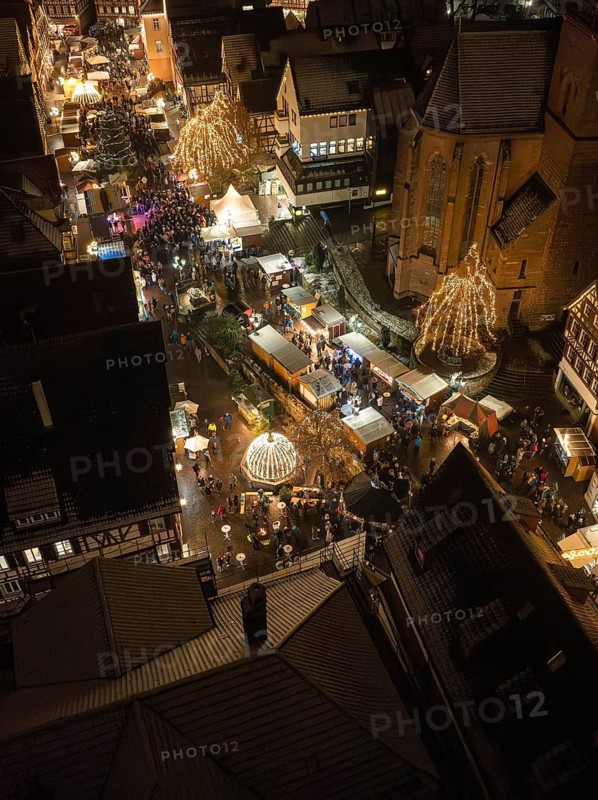 Popular Christmas market with festive lights and church tower in the background, Christmas market Calw, Black Forest, Germany
