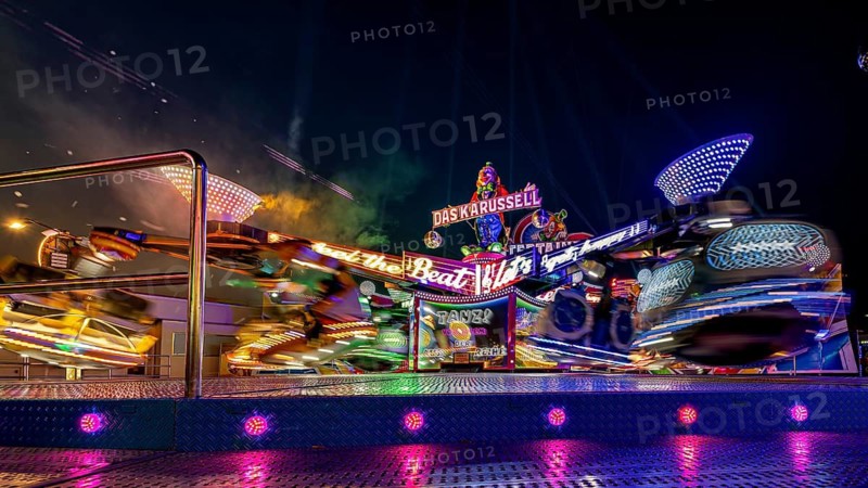 Moving, colorful carousel at night at a lively fair, carousel and hustle and bustle of summer winnings in Eisenach